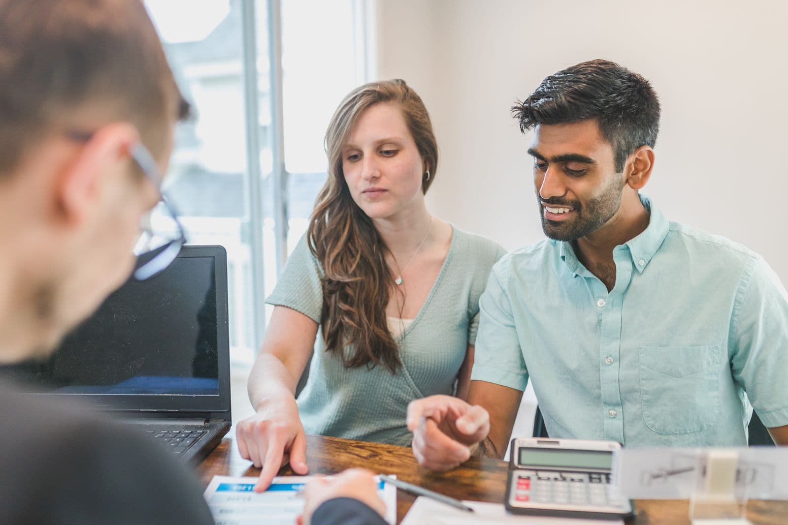 A couple going through their finances in a meeting